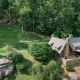 Aerial view of rustic mountain wedding venue in North Carolina with outdoor ceremony space and forest backdrop