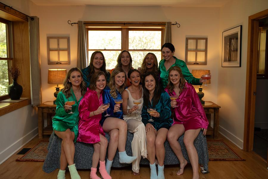 Bride celebrating with her bridesmaids while getting ready at Laurel Falls wedding venue