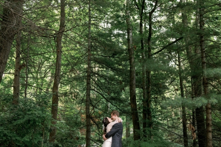 Bride and groom hugging in the forest during Laurel Falls wedding portraits