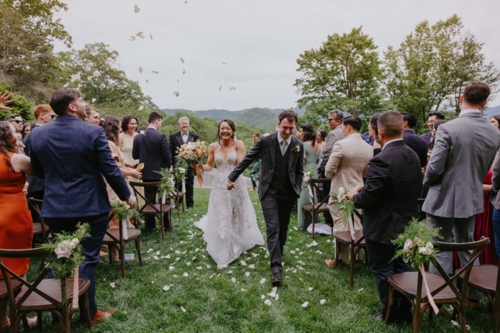 Newly married couple walks down the aisle after their Laurel Falls outdoor ceremony.