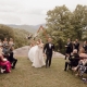 Newly married co.uple walking down the aisle at a mountain wedding ceremony.